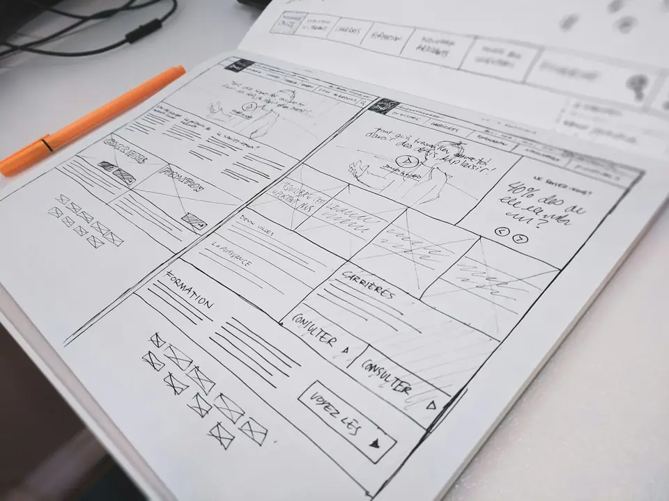 Hand-drawn website wireframe sketch on paper